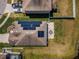 Birds-eye view of a modern home with solar panels and patio, showcasing modern upgrades at 9211 Seeger Ln, Land O Lakes, FL 34638