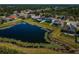 Community aerial view with pond, mature trees, and well-maintained lawns, emphasizing curb appeal at 9211 Seeger Ln, Land O Lakes, FL 34638