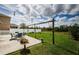 Picturesque backyard with a pergola, outdoor seating, and lush green grass at 9211 Seeger Ln, Land O Lakes, FL 34638