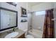 Bright bathroom featuring a shower-tub combination, modern vanity, and decorative artwork at 9211 Seeger Ln, Land O Lakes, FL 34638