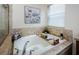 Soaking tub with tile surround next to window, featuring bath caddy with accessories at 9211 Seeger Ln, Land O Lakes, FL 34638