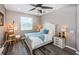 Inviting bedroom with stylish decor, wood floors, ceiling fan, and natural light at 9211 Seeger Ln, Land O Lakes, FL 34638