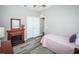 Comfortable bedroom showcasing a fireplace, wood-look floor, and an access to a closet at 9211 Seeger Ln, Land O Lakes, FL 34638