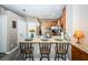 Kitchen island with granite countertops, bar seating, sink, and stainless steel appliances at 9211 Seeger Ln, Land O Lakes, FL 34638
