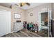 Well-lit office space with wood floors and a view into the adjacent living room at 9211 Seeger Ln, Land O Lakes, FL 34638