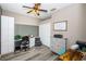 Well-lit office space with wood floors, built-in shelves, and a closet at 9211 Seeger Ln, Land O Lakes, FL 34638