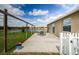 Concrete patio features outdoor seating, a pond view, and an attached pergola at 9211 Seeger Ln, Land O Lakes, FL 34638