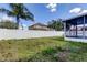 A shot of the white vinyl fence and backyard, also showing part of the screened-in patio on the home at 9407 Black Thorn Loop, Land O Lakes, FL 34638