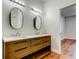 Bright bathroom featuring double vanity and access to bedroom at 9407 Black Thorn Loop, Land O Lakes, FL 34638