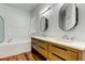 Bright bathroom featuring double vanity and soaking tub at 9407 Black Thorn Loop, Land O Lakes, FL 34638