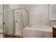Bright bathroom featuring soaking tub and glass-enclosed shower at 9407 Black Thorn Loop, Land O Lakes, FL 34638