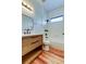 Bathroom featuring wood vanity, white countertops, and tile shower with tub at 9407 Black Thorn Loop, Land O Lakes, FL 34638
