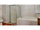 Bright bathroom featuring soaking tub and glass-enclosed shower at 9407 Black Thorn Loop, Land O Lakes, FL 34638