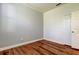 Bedroom with wood-look flooring, neutral paint, and closet at 9407 Black Thorn Loop, Land O Lakes, FL 34638