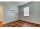 Bedroom featuring wood-look flooring, neutral paint, and window for natural light at 9407 Black Thorn Loop, Land O Lakes, FL 34638