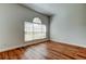 Cozy room showcasing hardwood floors, a large window with blinds, and neutral walls with electrical outlets at 9407 Black Thorn Loop, Land O Lakes, FL 34638