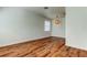 Spacious room featuring hardwood floors, neutral walls, a window with blinds, and a pendant light fixture at 9407 Black Thorn Loop, Land O Lakes, FL 34638