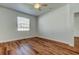 Bright bedroom features wood-look floors and a ceiling fan at 9407 Black Thorn Loop, Land O Lakes, FL 34638
