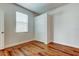Bright bedroom features wood-look floors, a window, and a closet at 9407 Black Thorn Loop, Land O Lakes, FL 34638