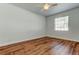 Bright bedroom features wood-look floors and a ceiling fan at 9407 Black Thorn Loop, Land O Lakes, FL 34638
