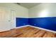 Bedroom showcasing wood-look flooring, bright neutral paint, and closet at 9407 Black Thorn Loop, Land O Lakes, FL 34638