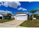 Charming single-story home with gray exterior, an attached two-car garage, and a well-manicured lawn at 9407 Black Thorn Loop, Land O Lakes, FL 34638