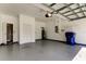 A spacious garage, featuring a clean epoxy floor, neutral-toned walls, and ample overhead lighting at 9407 Black Thorn Loop, Land O Lakes, FL 34638