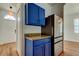 Kitchenette featuring stainless steel appliances, blue cabinets, and wood-look flooring at 9407 Black Thorn Loop, Land O Lakes, FL 34638
