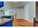 Bright kitchen with stainless steel appliances and blue cabinets, and a wood-look floor at 9407 Black Thorn Loop, Land O Lakes, FL 34638
