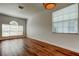 Bright and airy room featuring hardwood floors, multiple windows with blinds, and neutral walls with electrical outlets at 9407 Black Thorn Loop, Land O Lakes, FL 34638
