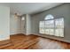 Bright living area with hardwood floors, arched windows, and a white front door offering natural light at 9407 Black Thorn Loop, Land O Lakes, FL 34638