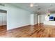 Open living area with wood floors, modern lighting, and breakfast bar to the kitchen at 9407 Black Thorn Loop, Land O Lakes, FL 34638