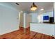 Open living area with wood floors, modern lighting, and breakfast bar to the kitchen at 9407 Black Thorn Loop, Land O Lakes, FL 34638