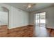 Bright living room with wood floors and sliding glass doors leading to an enclosed patio at 9407 Black Thorn Loop, Land O Lakes, FL 34638