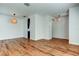 Open-concept living room with hardwood floors, arched doorways, modern lighting, and neutral paint, bright and airy at 9407 Black Thorn Loop, Land O Lakes, FL 34638