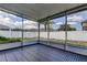 The screened-in patio overlooks a backyard with a well-maintained white fence and a lush lawn at 9407 Black Thorn Loop, Land O Lakes, FL 34638