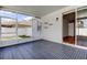 Covered and screened patio featuring custom shelving, sliding glass doors, and durable tile flooring at 9407 Black Thorn Loop, Land O Lakes, FL 34638