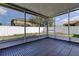 The screened-in patio has a blue tile floor and overlooks the backyard with a white vinyl fence at 9407 Black Thorn Loop, Land O Lakes, FL 34638