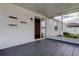 A view of the covered and screened patio featuring custom shelving and sliding glass doors to the indoors at 9407 Black Thorn Loop, Land O Lakes, FL 34638