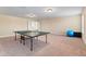 Large carpeted bonus room featuring a ping pong table and neutral paint at 9614 Orange Jasmine Way, Tampa, FL 33647