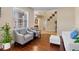 Cozy living room with hardwood floors, natural light, and a view of the staircase at 9614 Orange Jasmine Way, Tampa, FL 33647