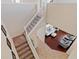 Carpeted staircase with railing leading to the hardwood floored living room below at 9614 Orange Jasmine Way, Tampa, FL 33647