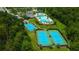 Aerial view of tennis courts and pool offering opportunities for recreation and relaxation at 9614 Orange Jasmine Way, Tampa, FL 33647