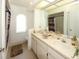 Bathroom featuring double sinks, large vanity, and bright lighting at 9805 Hermosillo Dr, New Port Richey, FL 34655