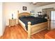 Spacious bedroom featuring hardwood floors and a king-size bed, illuminated by natural light at 9805 Hermosillo Dr, New Port Richey, FL 34655