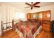 Spacious bedroom with custom headboard, built-in storage, and ceiling fan at 9805 Hermosillo Dr, New Port Richey, FL 34655