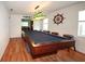 Spacious game room with a pool table, nautical decor, and hardwood floors at 9805 Hermosillo Dr, New Port Richey, FL 34655