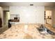 Kitchen island with sink, tile countertops, and ample storage cabinets at 9805 Hermosillo Dr, New Port Richey, FL 34655