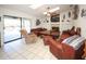 Cozy living room with comfortable seating, a fireplace, and access to the patio, perfect for relaxing and entertaining at 9805 Hermosillo Dr, New Port Richey, FL 34655