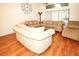 Bright living room features comfortable sofas, large windows, and a ceiling fan, creating an inviting space for relaxation at 9805 Hermosillo Dr, New Port Richey, FL 34655